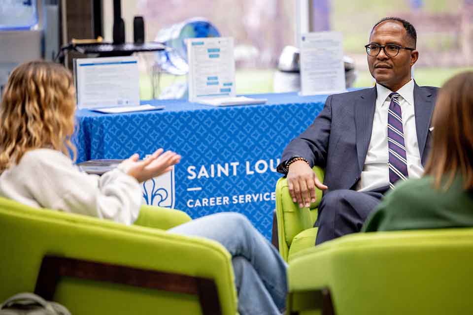 SLU's head of career services talks to students, seen seated from behind