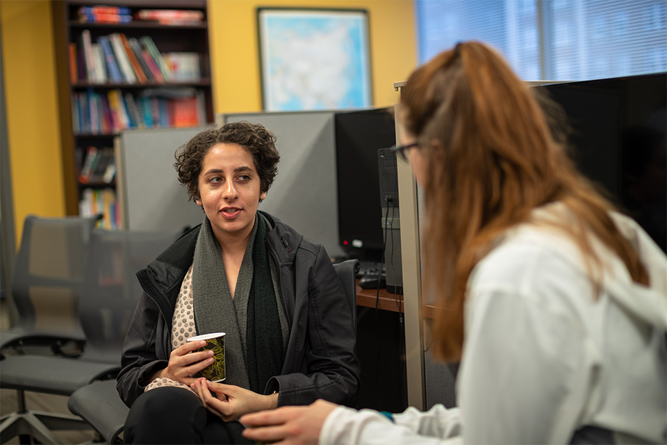 Two students chat at Polyglot Café