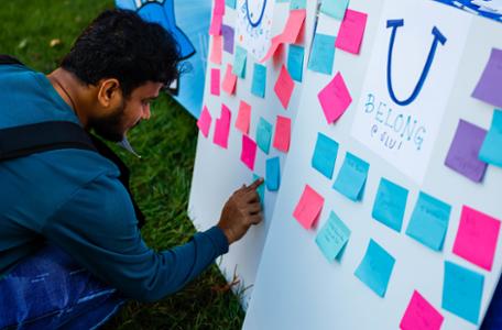 A board with post it notes says U Belong at SLU