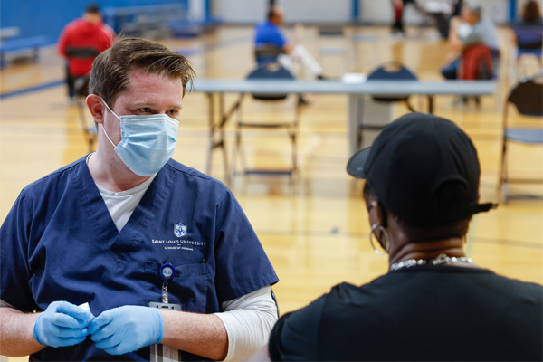 Vaccine clinic nurse distributing a vaccine to a citizen population