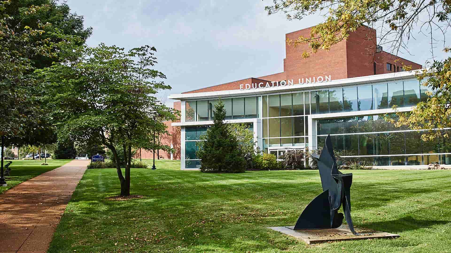 An exterior view of the glassed front of the Health Sciences Education Union on a sunny afternoon.