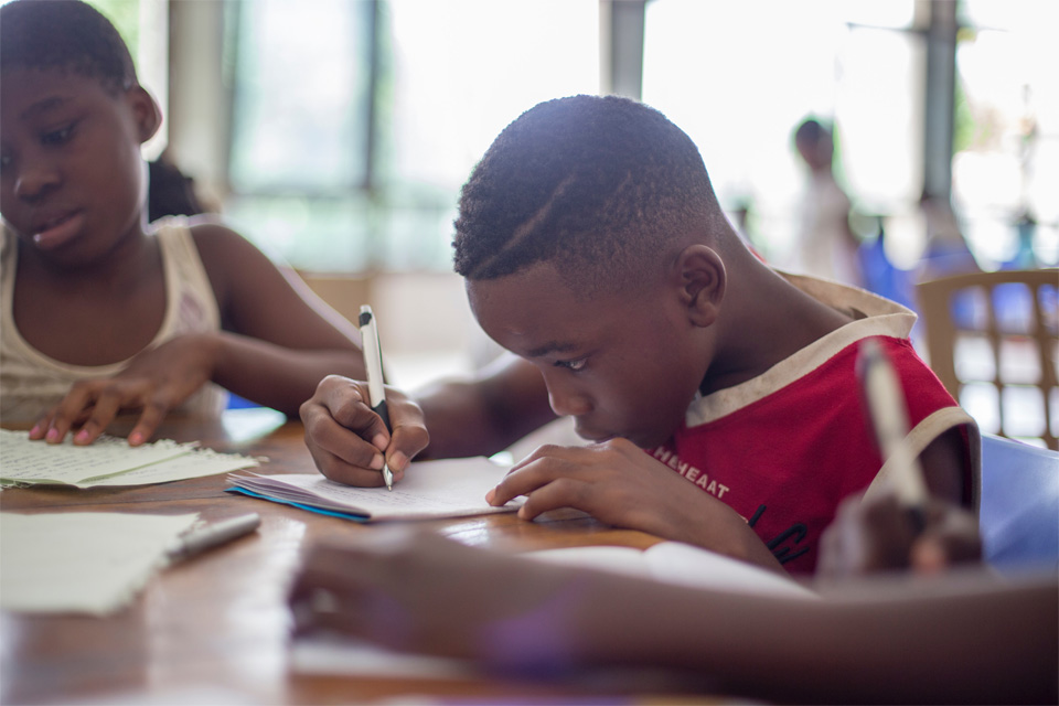 Picture of a young boy during class doing homework