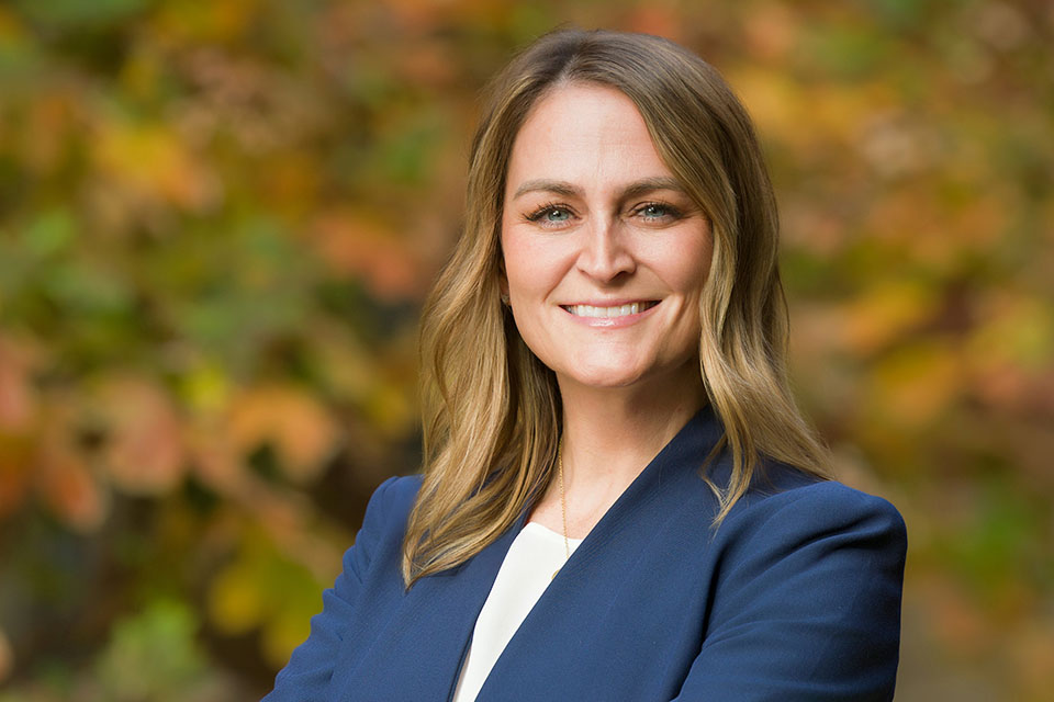 Marcea Walter smiles for a photo outdoors on a fall day.
