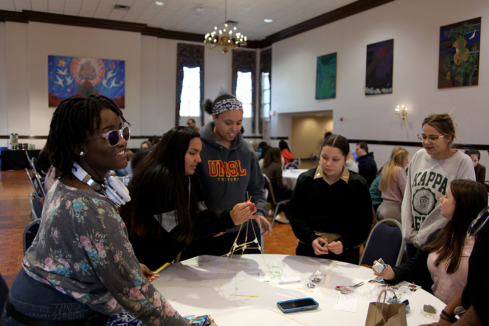 Girls participating in "Introduce a Girl to Engineering Day" 2020 build a structure from spaghetti.