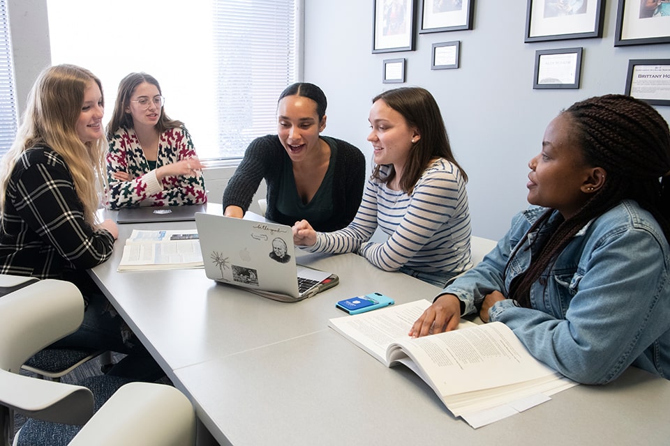 SLU School of Education students at a table