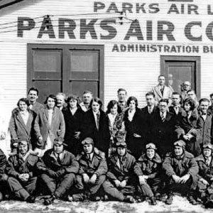 Students, faculty and staff pose in front of the main administrative building.